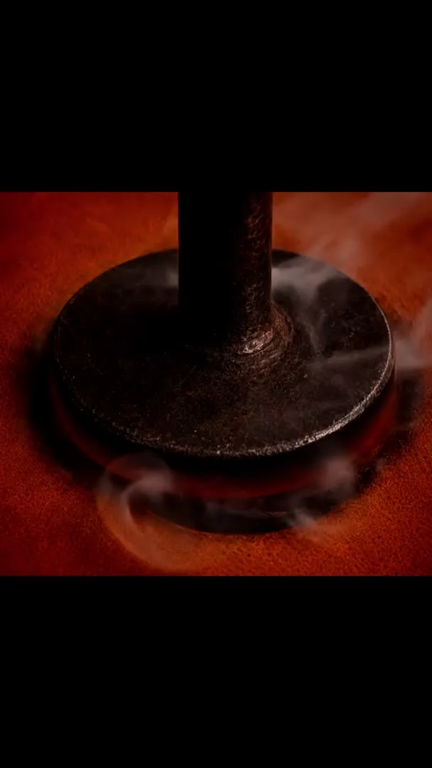 The Creative Flow Studio logo branded into leather